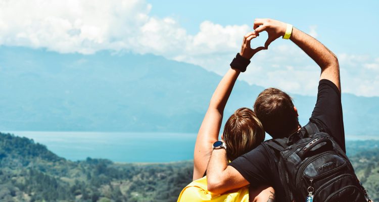sugar-daddy-sugar-baby-travel-love › Sugarbook | No.1 Trusted Sugar Daddy & Real Sugar Baby Platform in the U.S. Couple making a heart shape with hands while traveling, symbolizing Sugar Daddy and Sugar Baby romance