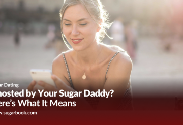 A young woman smiling softly while looking at her phone, representing a Sugar Baby reading a message before being ghosted by her Sugar Daddy.